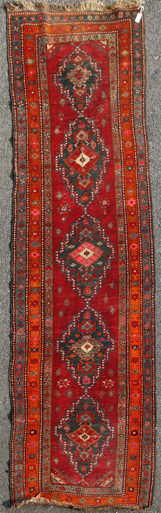 A Karabagh red ground runner c.1910, 12ft 5in by 3ft 11in.